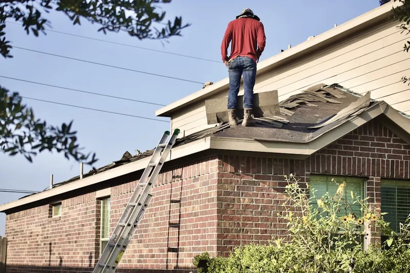 Professional roofer working on a residential roof in Marplewoods